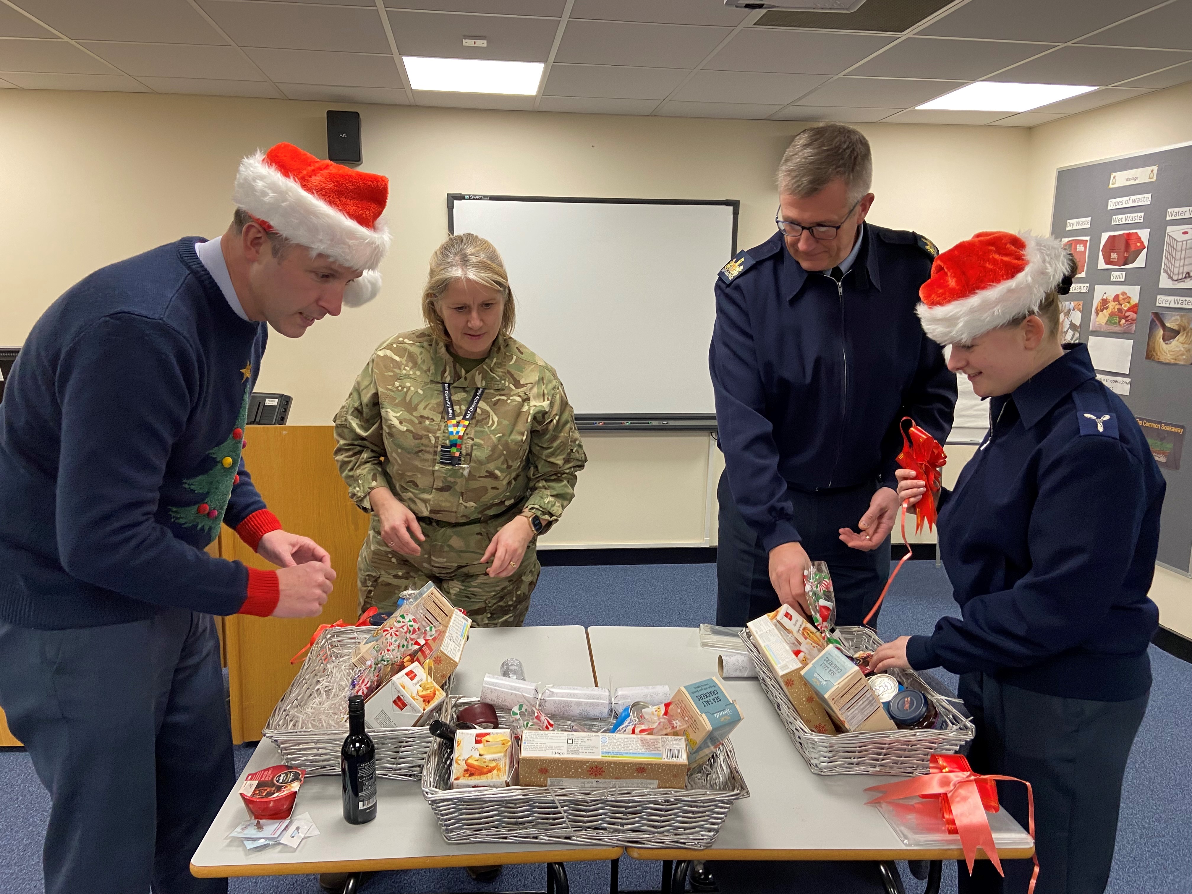 From Left: RAF Wittering Station Commander Wg Cdr Jez Case, OC 3MCS & RAFA Wittering & District Branch Chair Sqn Ldr Sara Jones, Station Warrant Officer WO Darren Rose and AS1 Annie Nicol putting the Christmas hampers together for local veterans